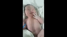 Dad soothes crying baby by talking to him calmly