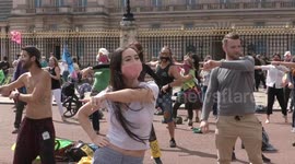 Hundreds of Extinction Rebellion protesters disco dance outside Buckingham Palace in London