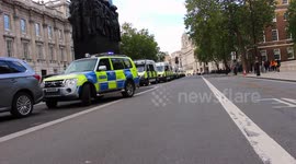 rows of police vehicles line whitehall in response to protests