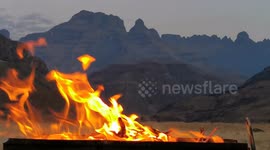 Flames of fire on barbecue in African mountains, night