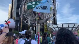 Climate activists climb globe outside Trump Hotel in New York