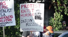 Black Lives Matter Protesters hold signs for justice for Dijon Kizzee
