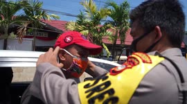 Police in Indonesia distribute face masks to residents