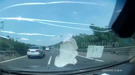Wooden bar smashes car front windscreen on Chinese highway