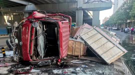 Transport truck falls from overpass and almost crushes motorcyclist in northern China