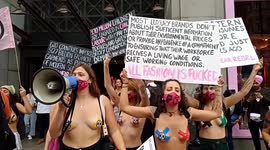 Semi-naked Extinction Rebellion protesters march through London and Glue hands to H&M windows, against fashion industry