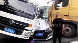 Chinese motorist shouts for help after car is crushed in between two trucks