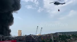 Helicopter drops water on huge blaze at Beirut port