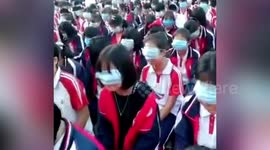 Middle school students in China use face masks to cover eyes during gratitude education