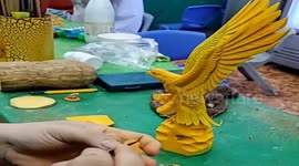 Vietnamese man carving hawk flying from pumpkins