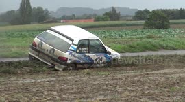 Racing car goes off the road and is stuck in the mud