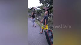 Teenagers drag karaoke machine along road in the Philippines