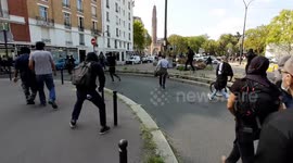 Protesters try to charge the police but are repelled by tear gas