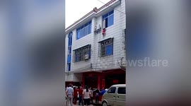 Chinese neighbours catch girl falling from second floor of building with duvet