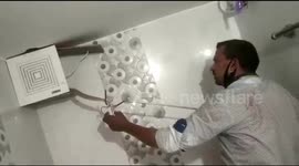 Aggressive cobra removed from Indian villager's bathroom fan