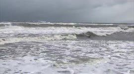 Surfer braves strong tides caused Hurricane Sally in Alabama