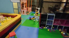 This toddler spontaneously tidying up indoor playground without asking him to do so