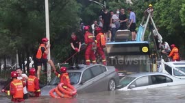 Firefighters rescue passengers trapped on bus roof after flood submerges road in southern China