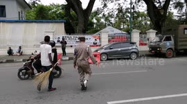 Anti-maskers forced to clean streets for breaching COVID-19 restrictions in Indonesia
