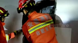 Chinese firefighters tear down wall to free people trapped in lift