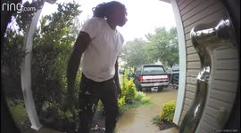 Man Slips In Rain Perfectly Captured By The Door Camera