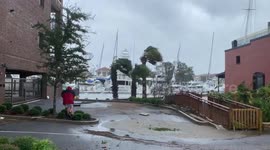 Pensacola residents struggle to walk as strong winds from Hurricane Sally batter Florida