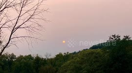 Large fiery sun sets in the sky