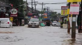 Vehicles drive through flooded streets as Typhoon Noul approaches Thailand