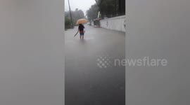 Residents wade through flooded streets as Typhoon Noul approaches northern Thailand
