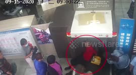 Chinese man lays on conveyor belt to skip long queues at train station