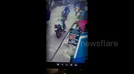 Security cam captures moment biker performs amazing swerve to miss oncoming bus