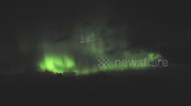 Bright pink meteor flies across Northern Lights in stunning video