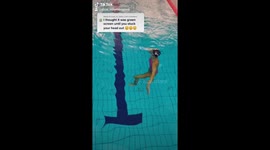 Artistic swimmer walks on invisible stairs - above the water view