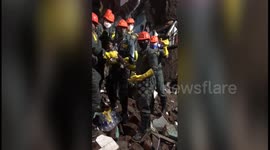 Moment child rescued from underneath debris of collapsed building in western India