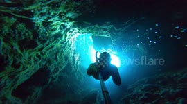 Look away if you're claustrophobic! Free diver swims through tiny tunnels in Menorca