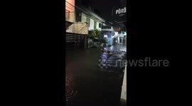 Children play in floodwaters as heavy rainfall hits Jakarta, Indonesia