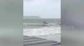 Fisherman rescued after capsizing in waves during Typhoon Noul in Cambodia