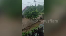 Car washed away by floods in Indonesia with at least three dead