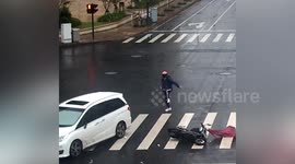 Chinese biker narrowly avoids serious injury after being crashed into by car