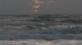 Spooky 'Jack O Lantern' face appears in the clouds at sunrise in Florida