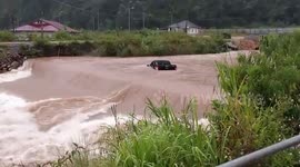 Car washed away by swollen river during typhoon in Laos