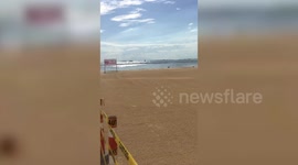 Woman poses in bikini on artificial white sand beach in the Philippines