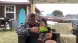 Finger licking good father teaching toddler son to suck his finger with Gerber Cheeto residues mimicking