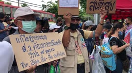 Protesters gather outside Parliament House in Bangkok as King visits country