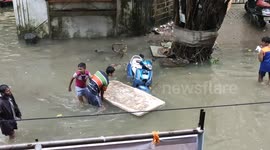 Kids play in flooded streets of Mumbai during torrential monsoon