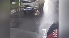 Helmet saves biker's life after he is run over by truck on Chinese road