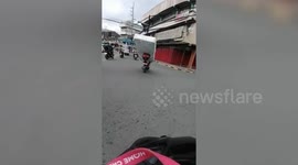 Motorcycle rider carries mattress on the back of his bike