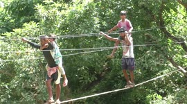 Villagers use electric overhead wire as bridge to cross river when local government doesn't build one