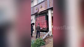 Chinese pedestrian narrowly avoids being hit by truck smashing into shop