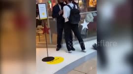 Shocking footage shows security guard and raging shopper come to blows outside Selfridge's store in row over entering with rollerblades
